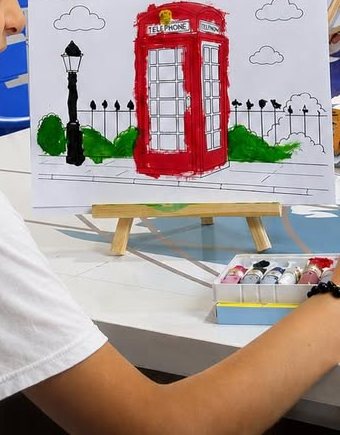 A painting of a London telephone box on an easel